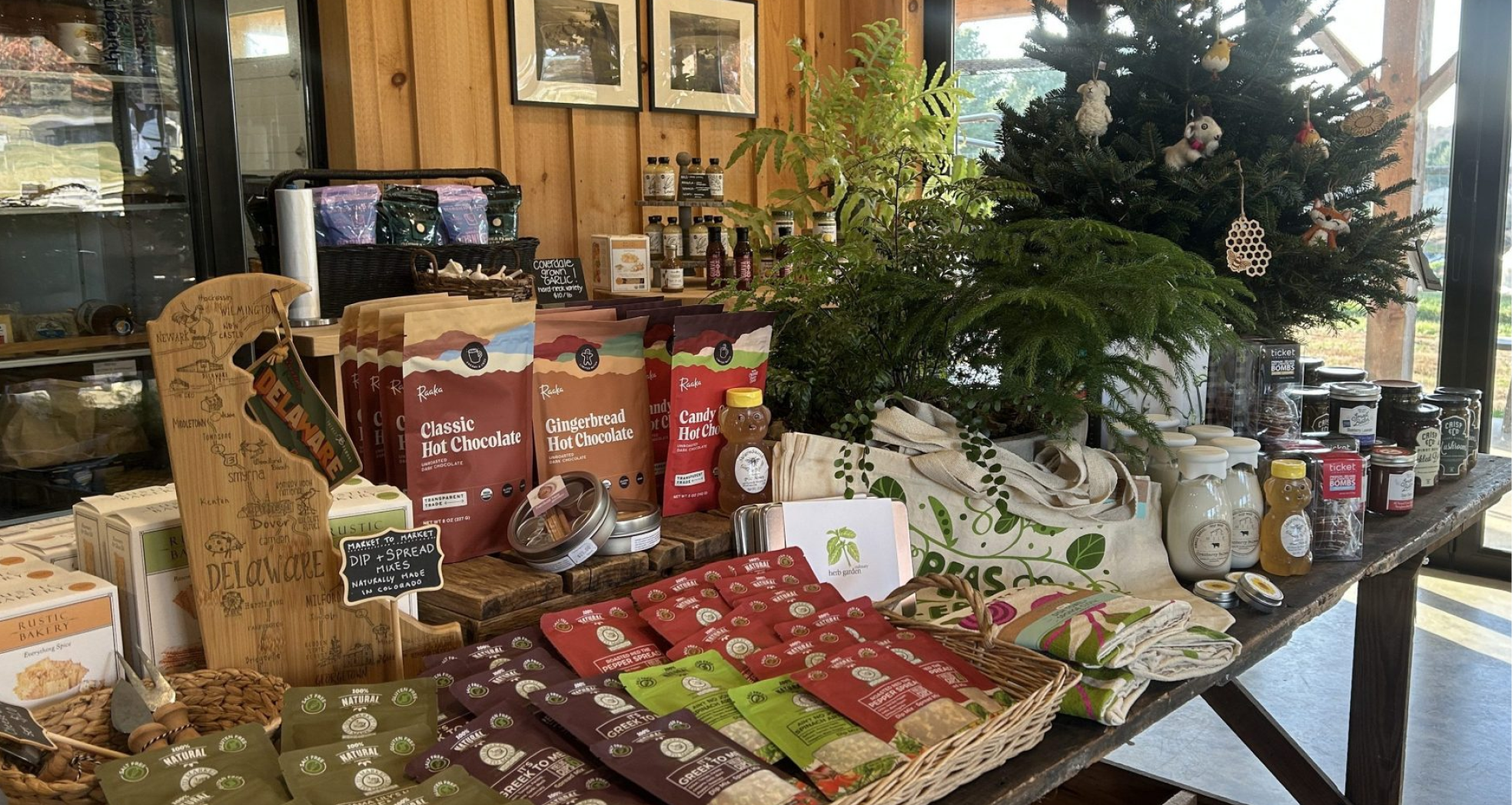 Market display with packaged goods, plants, and small gift items.