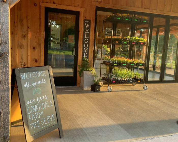Entrance to The Market at Coverdale with chalkboard sign outside.